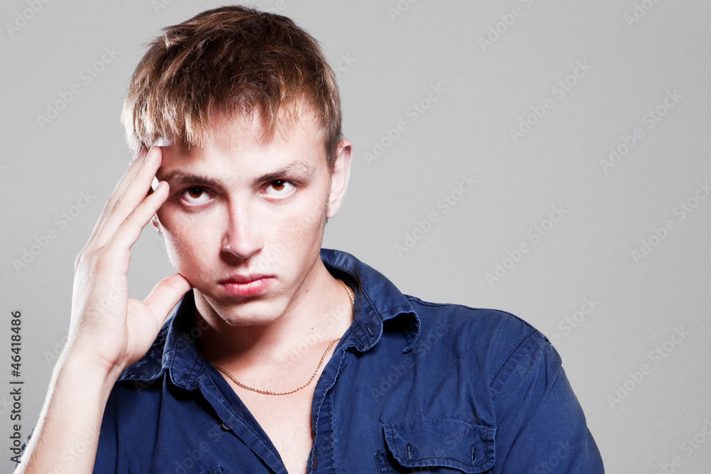 Young man holding hands on his head Young man holding hands on his head