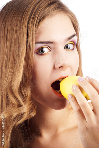 Girl biting a lemon