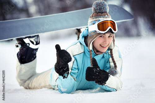 Female snowboarder showing thumbs up