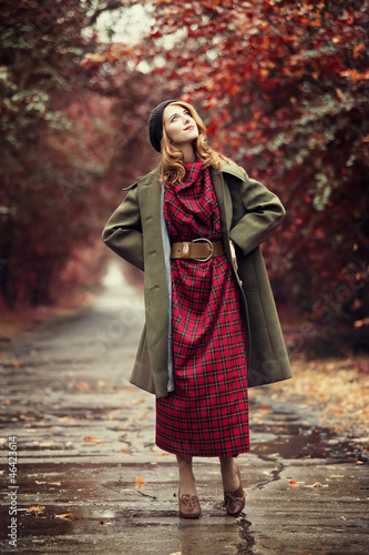 Style redhead girl at beautiful autumn alley.