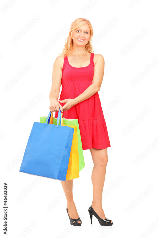 Smiling mature woman holding shopping bags