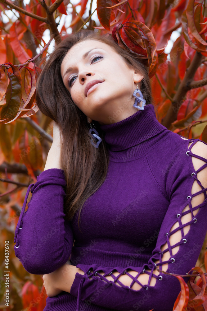 Beautiful woman in autunm garden