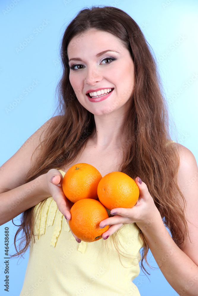 Beautiful woman with orange on blue background Beautiful woman with orange on blue background