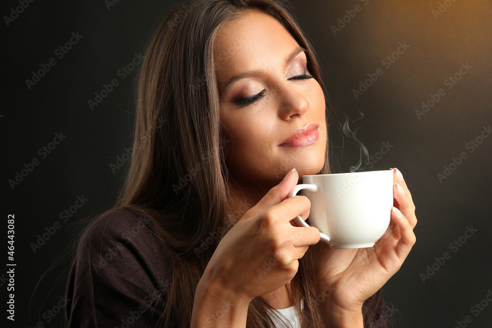 beautiful young woman with cup of coffee on brown background beautiful young woman with cup of coffee on brown background