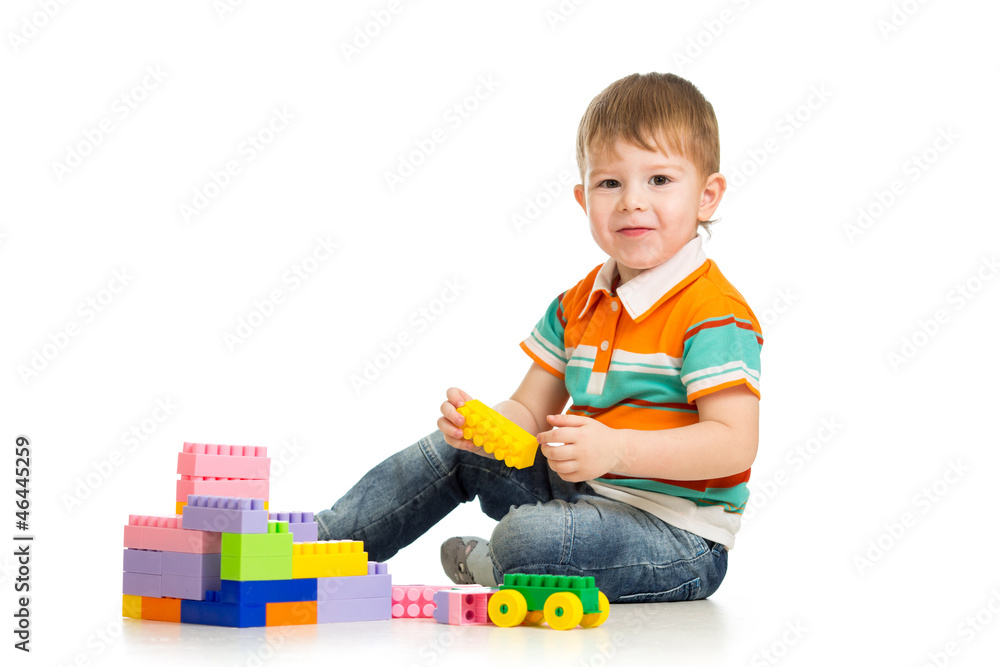 cheerful child boy playing with construction set over white back cheerful child boy playing with construction set over white back