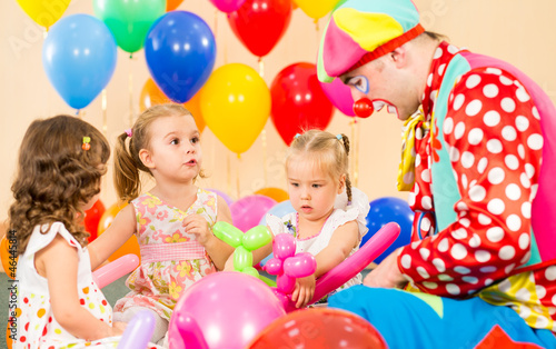 children girls and clown on birthday party