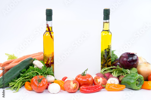 Fototapeta Naklejka Na Ścianę i Meble -  Paper for recipes between olive oil bottles and vegetable