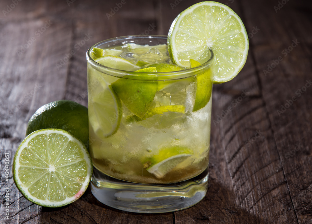 Glass with Caipirinha on wood Glass with Caipirinha on wood