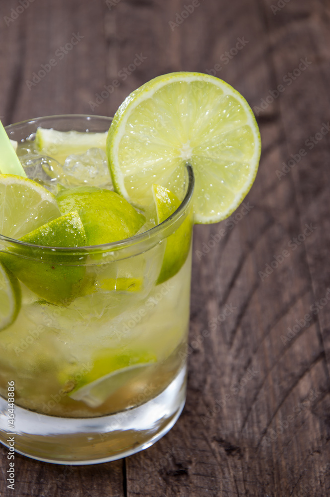 Glass with Caipirinha on wood Glass with Caipirinha on wood