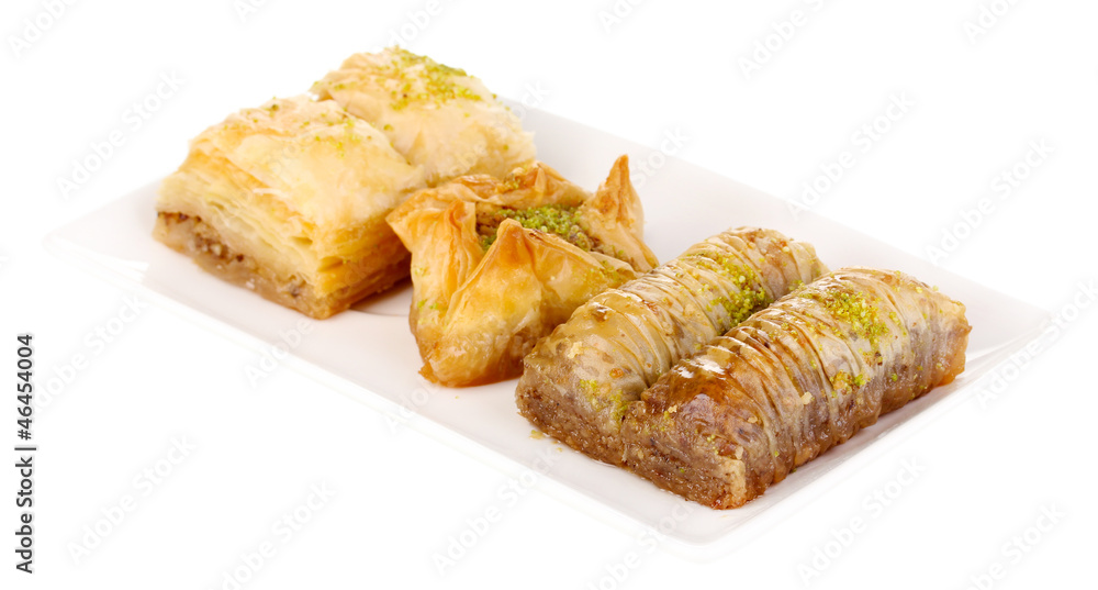 Sweet baklava on plate isolated on white Sweet baklava on plate isolated on white