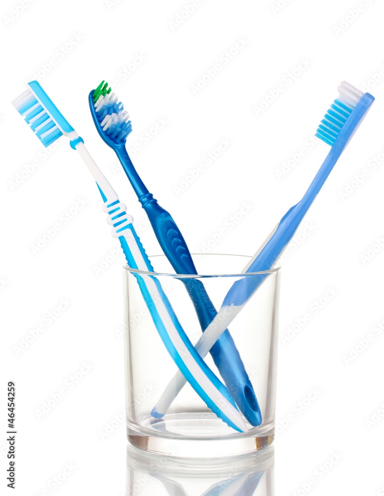Toothbrushes in glass isolated on white Toothbrushes in glass isolated on white