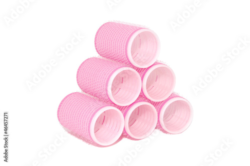 Six pink velcro rollers stacked in a pyramid