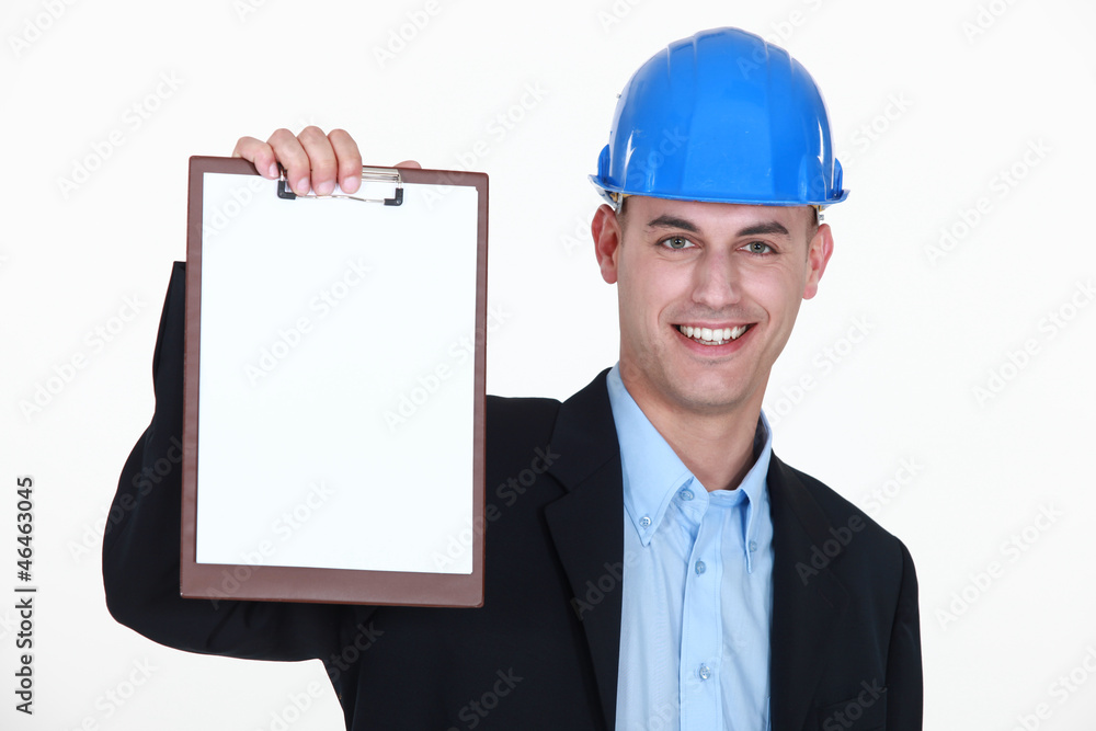 businessman wearing helmet and holding a notepad businessman wearing helmet and holding a notepad