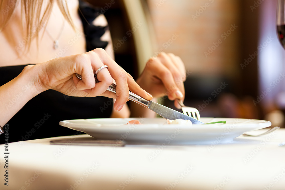 Woman having dinner at restaurant