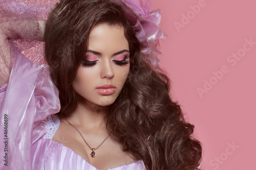 Glamour portrait of beautiful woman model with curly hair and br