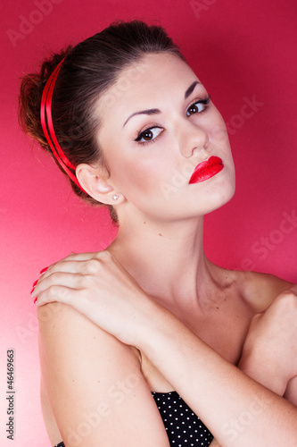 Pin-up girl with red ribbon in her hairs