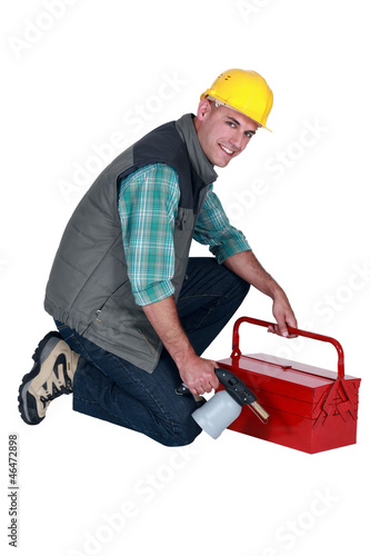 craftsman holding his tool box and welding torch