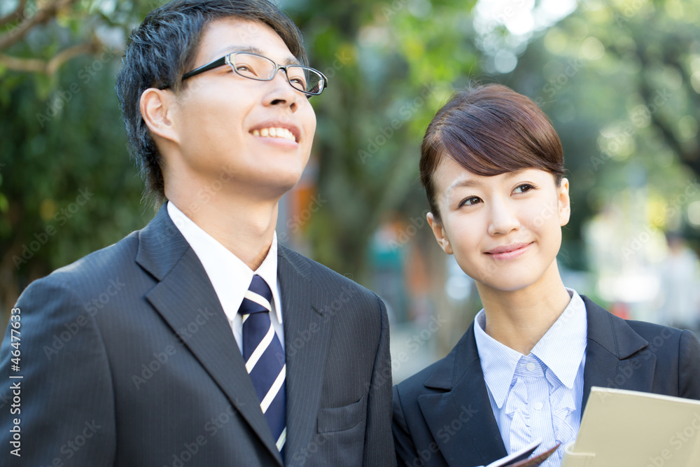 Young asian smiling businesswoman and businessman Young asian smiling businesswoman and businessman