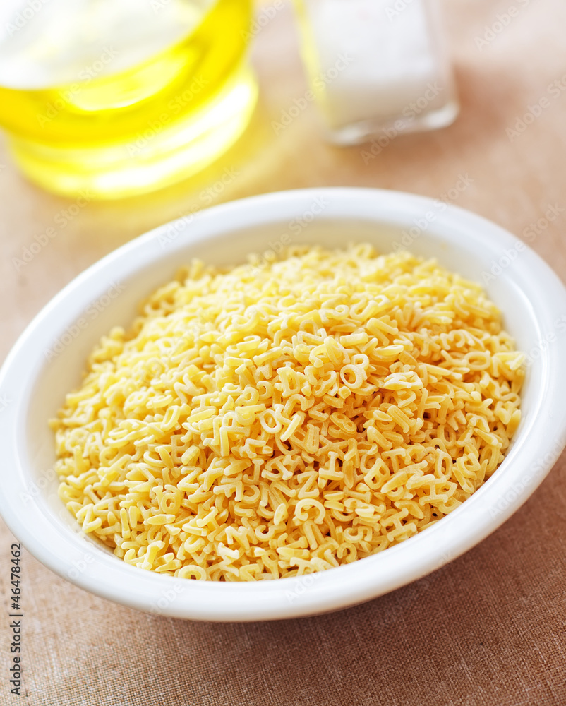 assortment of raw pasta and wheat on wooden background assortment of raw pasta and wheat on wooden background