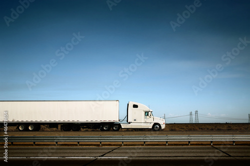 White truck on road over blue sky background