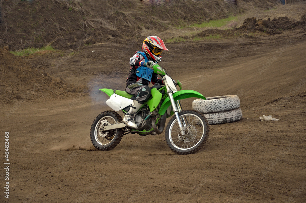 Motocross rider girl on a bend of the track MX Motocross rider girl on a bend of the track MX