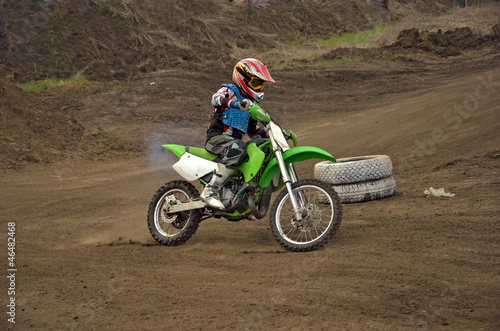 Fototapeta Naklejka Na Ścianę i Meble -  Motocross rider girl on a bend of the track MX