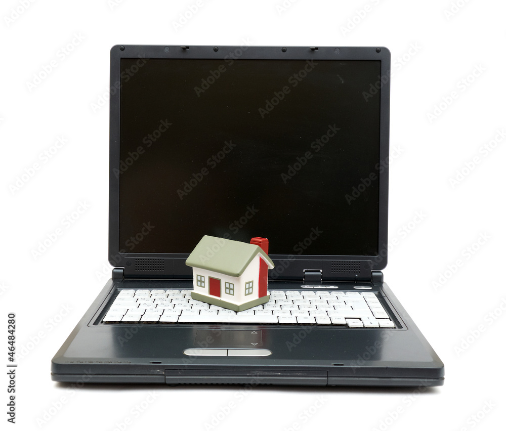 Toy House on laptop isolated on white backgroun Toy House on laptop isolated on white backgroun