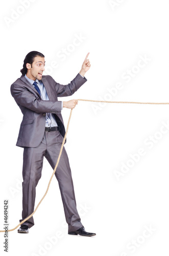 Businessman pulling rope on white