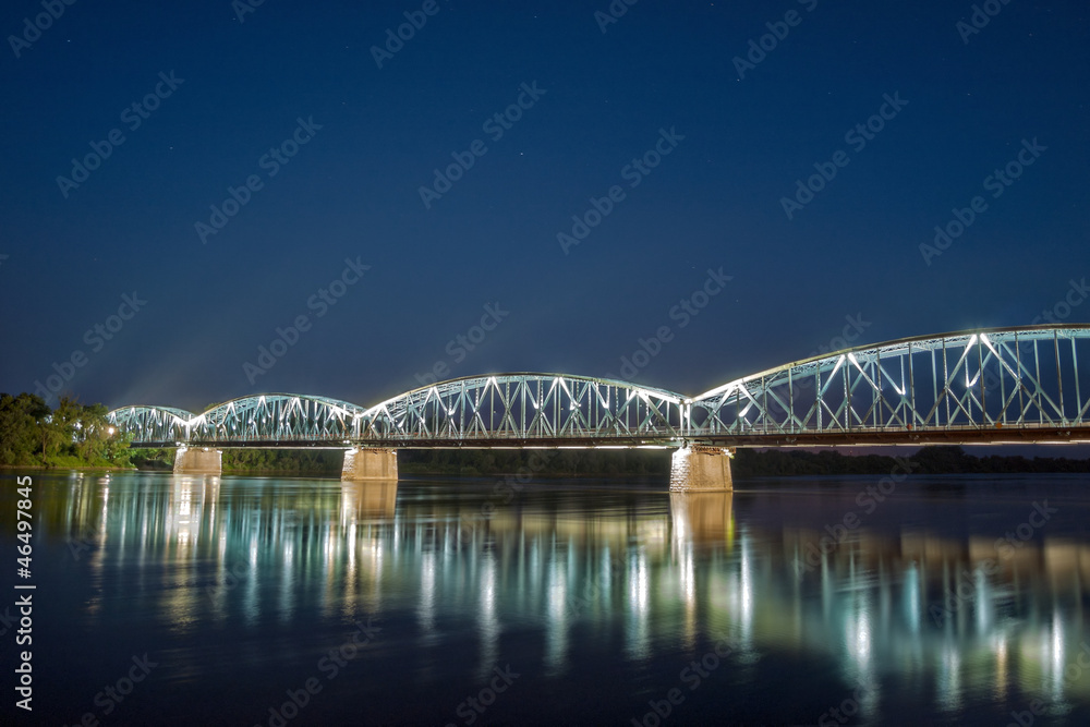 Bridge on Wisla river at night in Torun, Poland.