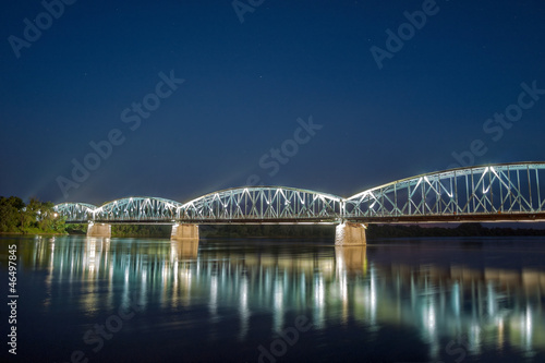 Bridge on Wisla river at night in Torun, Poland.