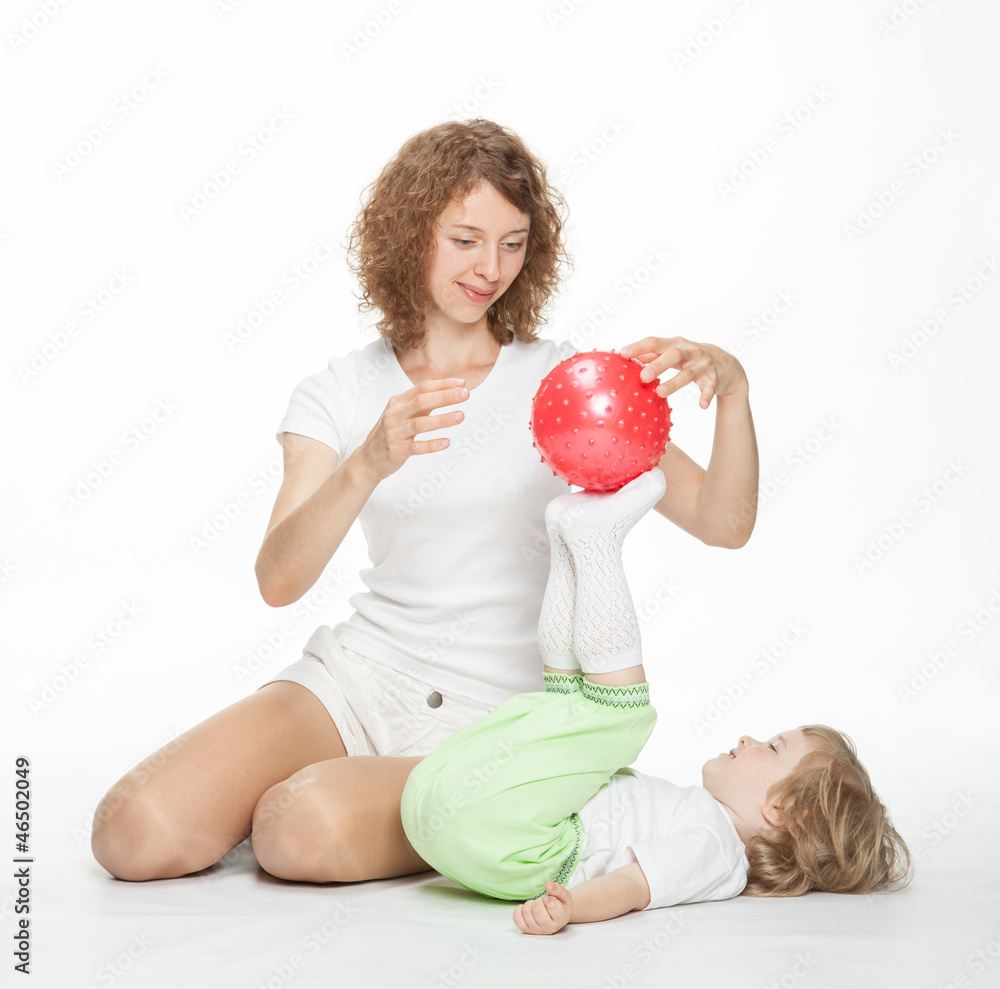 Happy mother doing sport exercises with little daughter Happy mother doing sport exercises with little daughter
