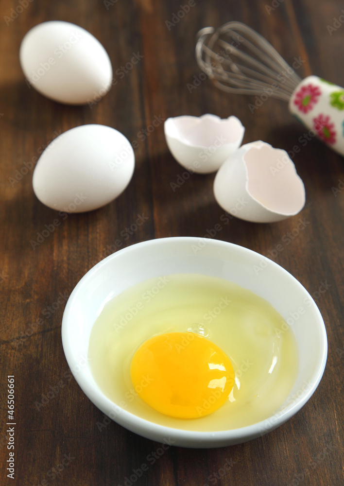 Cooking, whisk with eggs in a bowl and egg shells Cooking, whisk with eggs in a bowl and egg shells