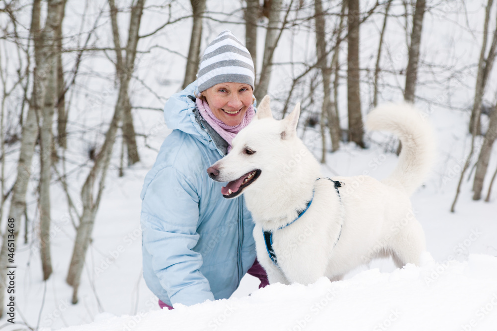 The woman with a dog in winter on walk The woman with a dog in winter on walk