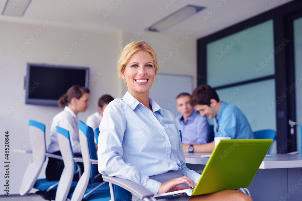 business woman with her staff in background at office business woman with her staff in background at office