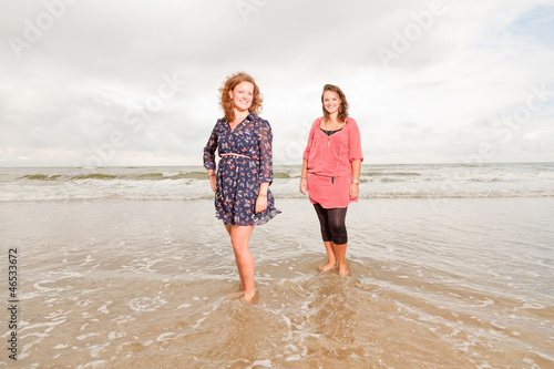Two pretty young women enjoying outdoor near the beach.
