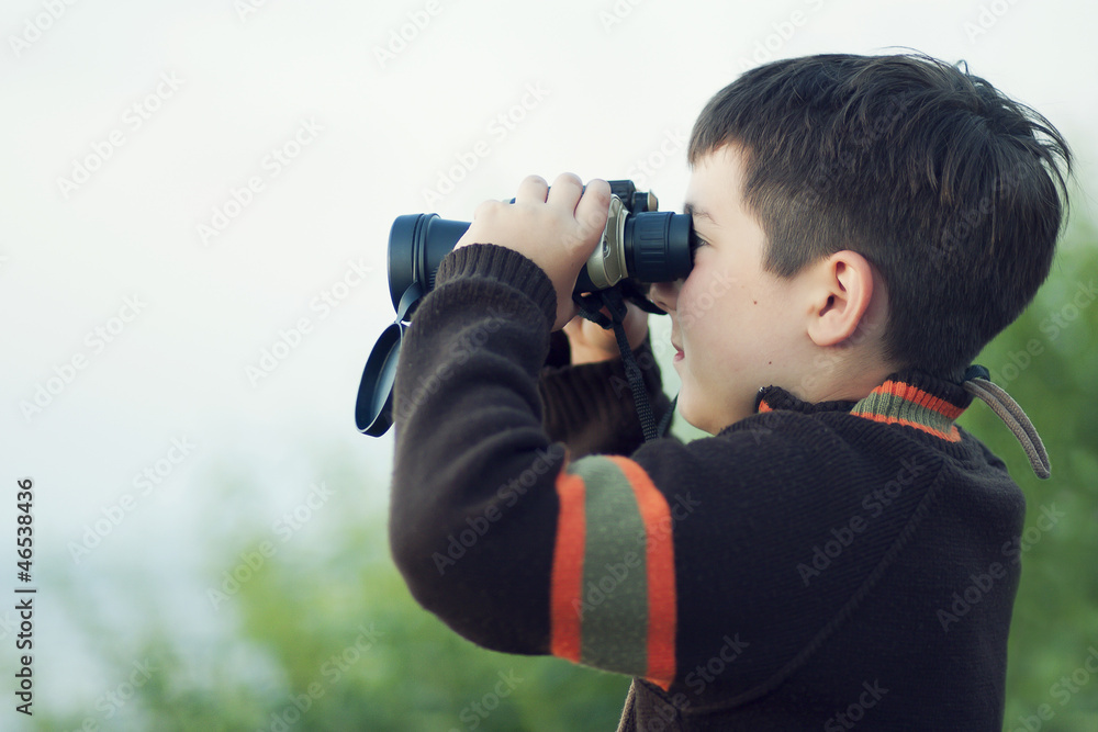 Boy looking through binocular Boy looking through binocular