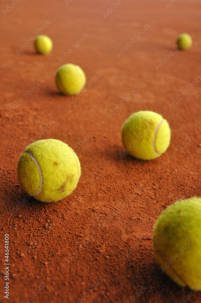 Six tennis balls on court
