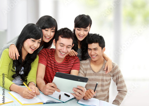Friendly group of students using tablet pc