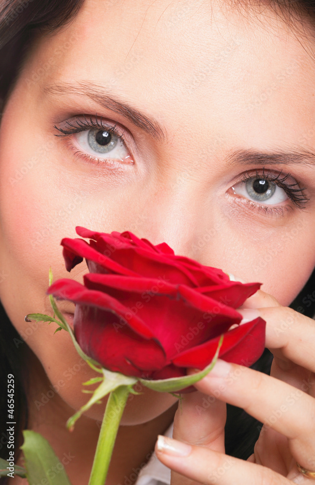 Closeup portrait of attractive young woman holding a red rose Closeup portrait of attractive young woman holding a red rose