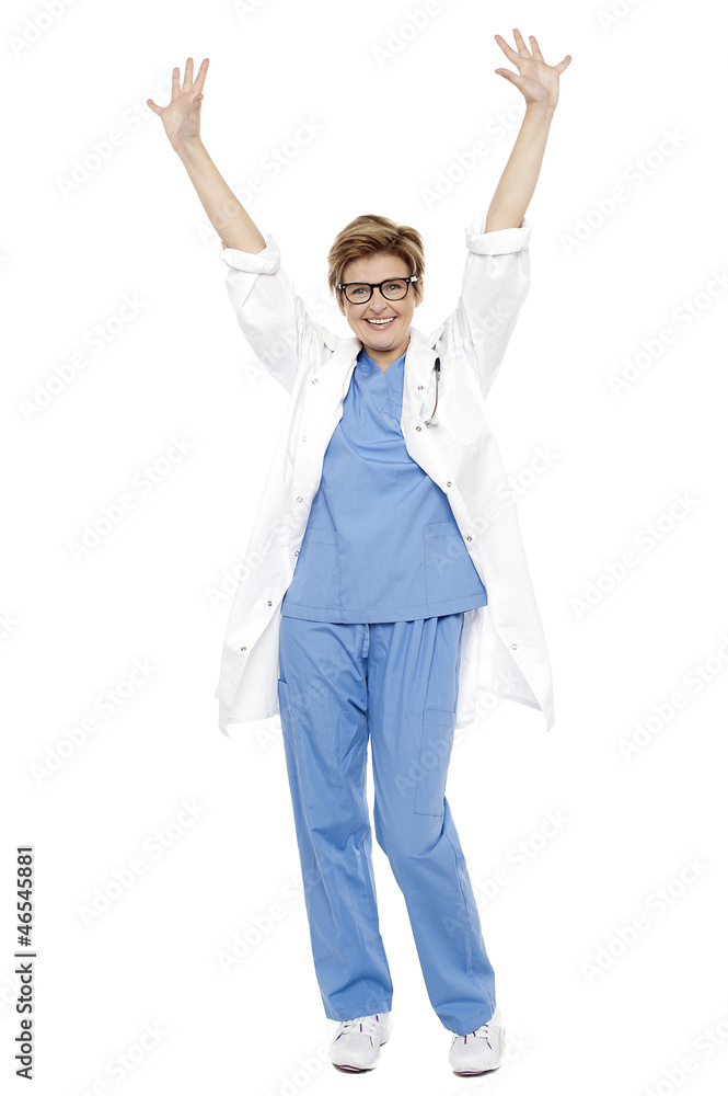Cheerful doctor raising her hands up in celebration Cheerful doctor raising her hands up in celebration