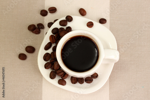Cup of coffee on brown background