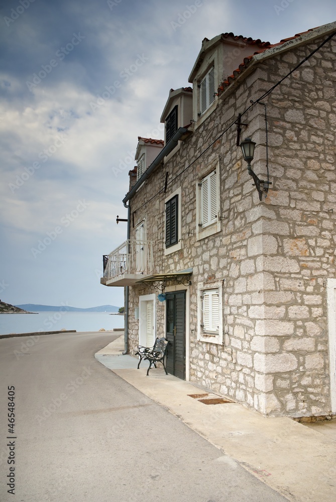 Old street of stone houses by the sea