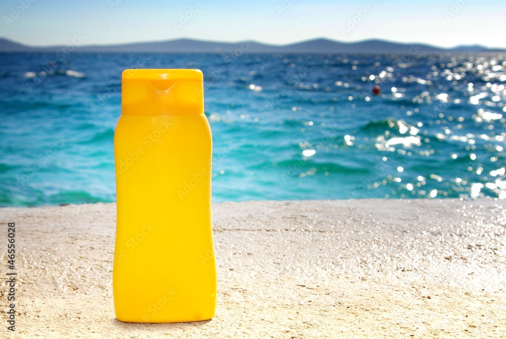 Sunbathing - suntan cream or oil on beach Sunbathing - suntan cream or oil on beach