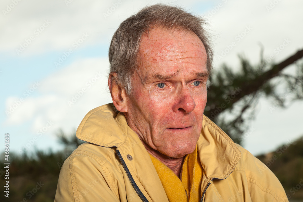 Senior man with yellow coat. Having cold. Sad looking. Senior man with yellow coat. Having cold. Sad looking.