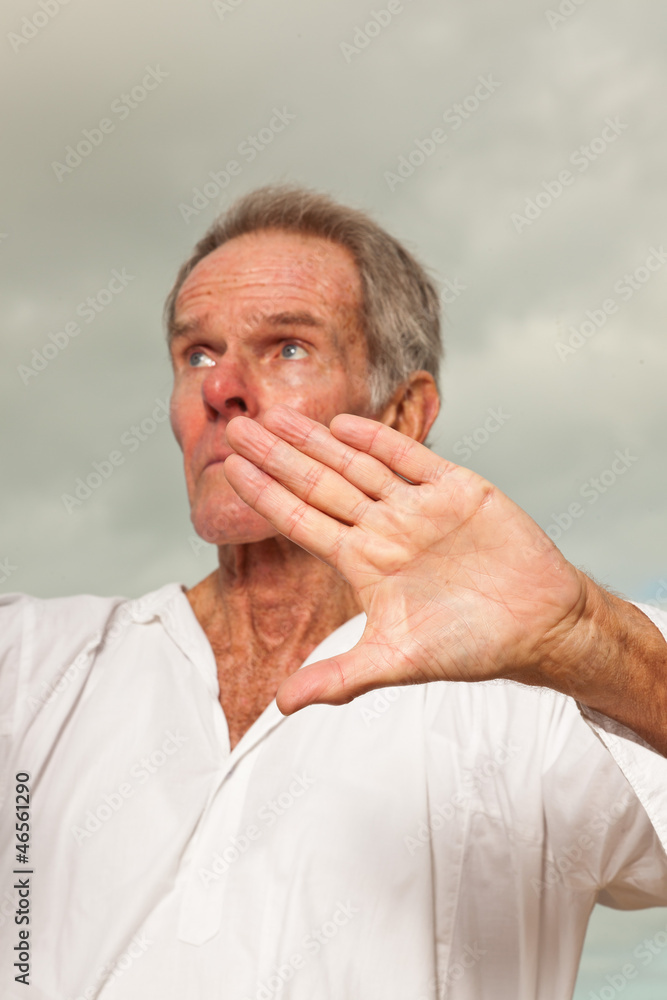Fototapeta premium Senior spiritual man dressed in white.Exercising outdoors.