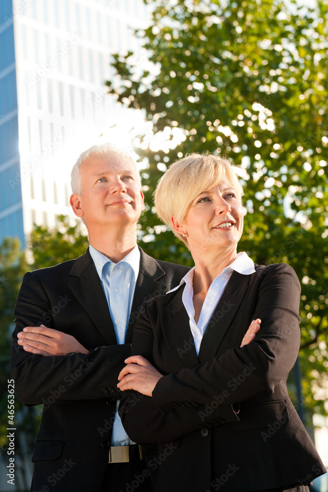 Business people in a park outdoors Business people in a park outdoors