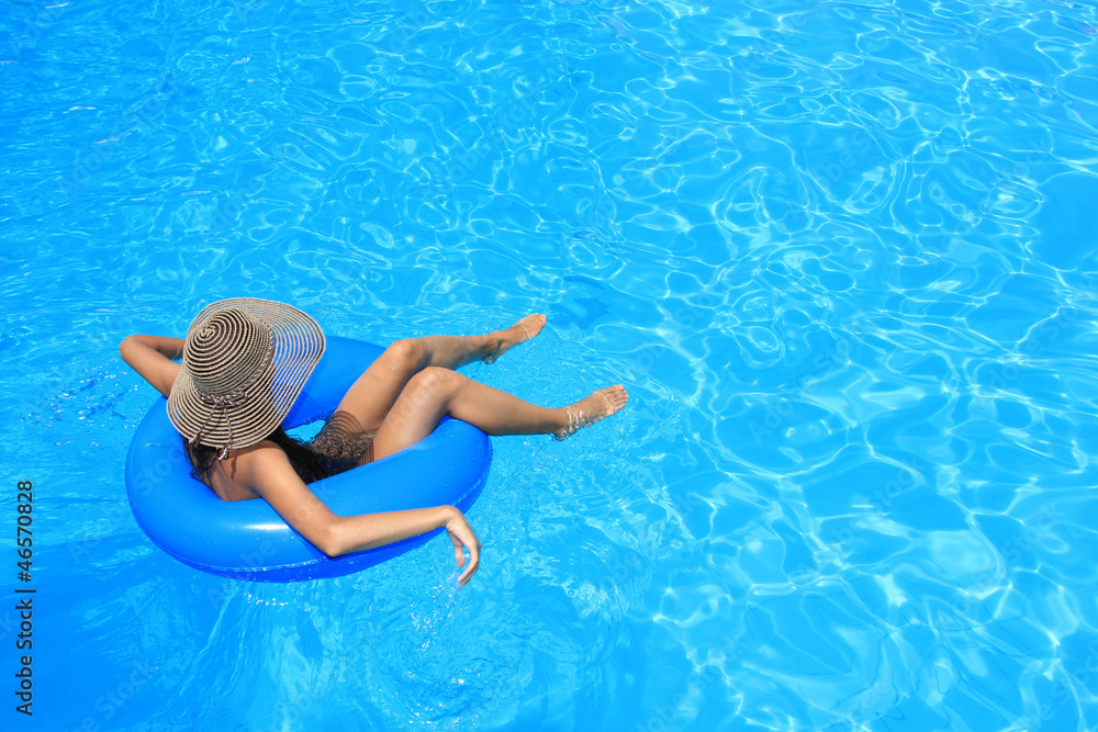 Woman in bikini and hat is in the water