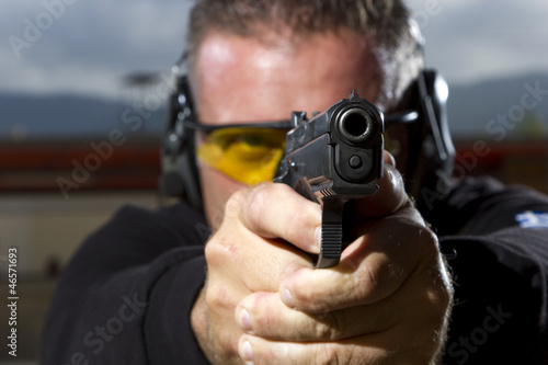 Man shooting  on an outdoor shooting range photo