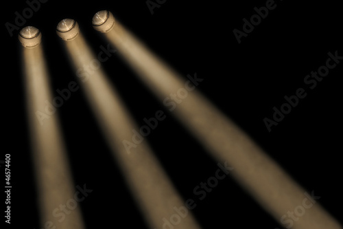 Three yellow spotlights in a smoky atmosphere