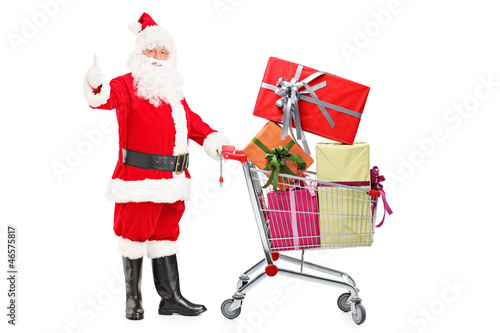 Santa Claus holding a cart full of gifts and giving a thumb up © Ljupco Smokovski